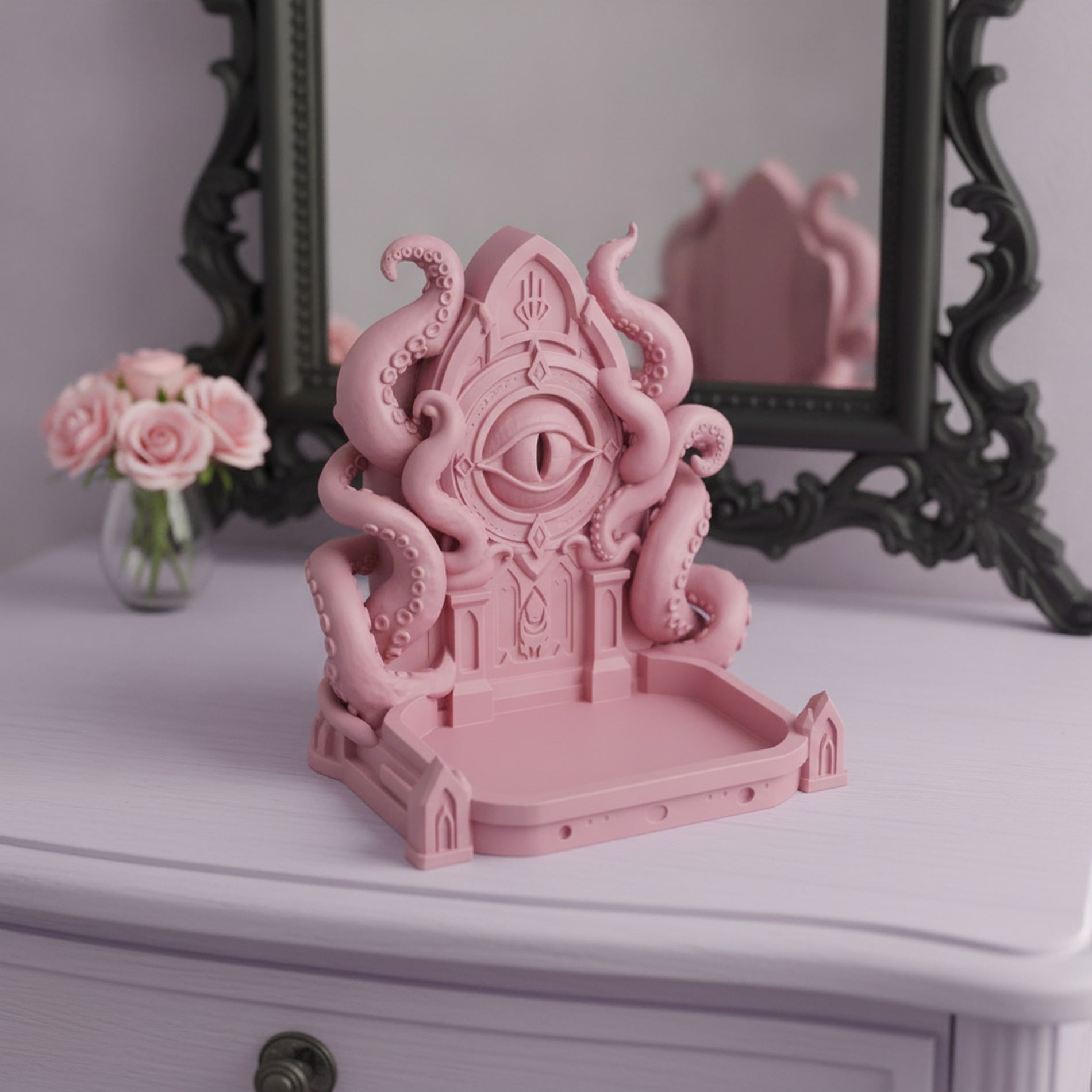Rosa Cthulhu-Schmuckschale, Dreiviertelansicht auf einem Frisiertisch vor einem Spiegel, leere Ablageschale, Rosenstrauß im Hintergrund