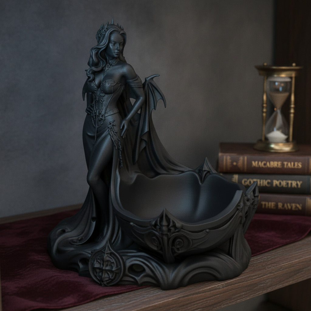 Gothic-Dämonin-Statue mit Fledermausflügeln und Dornenkrone, Frontalansicht mit integrierter Schmuckschale auf einem Bücherregal neben einer Sanduhr