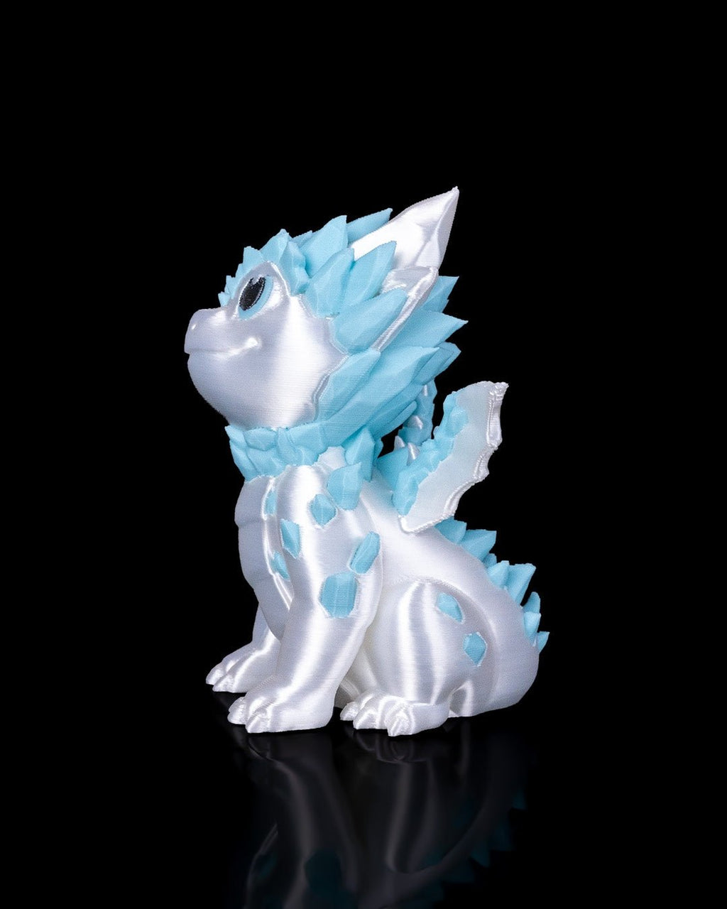 Weiß-blauer Eisdrache, Seitenansicht sitzend vor schwarzem Hintergrund