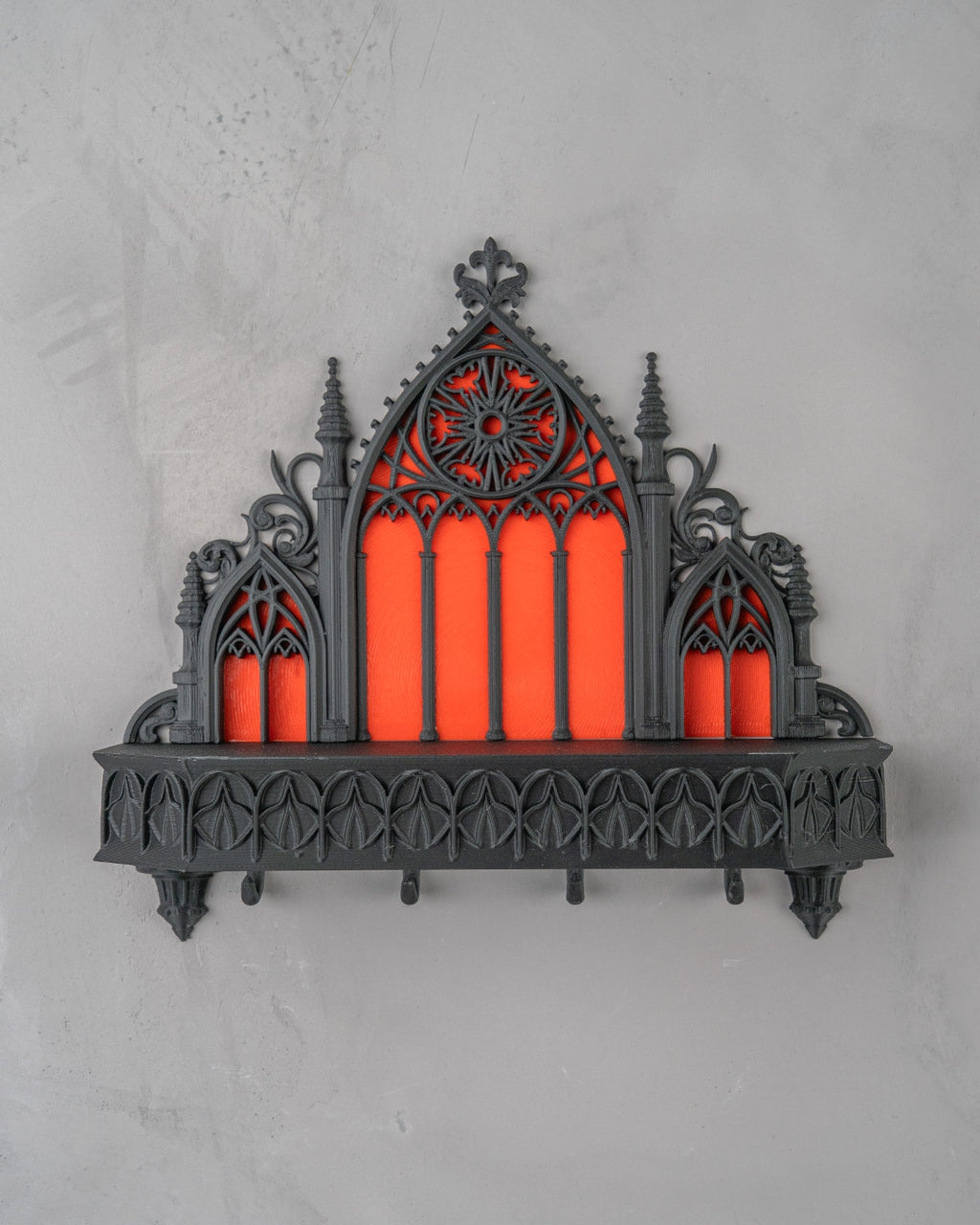 Gotischer Schlüsselhalter Kathedrale an heller Wand, Rosettenfenster und Zierleiste mit leeren Schlüsselhaken sichtbar