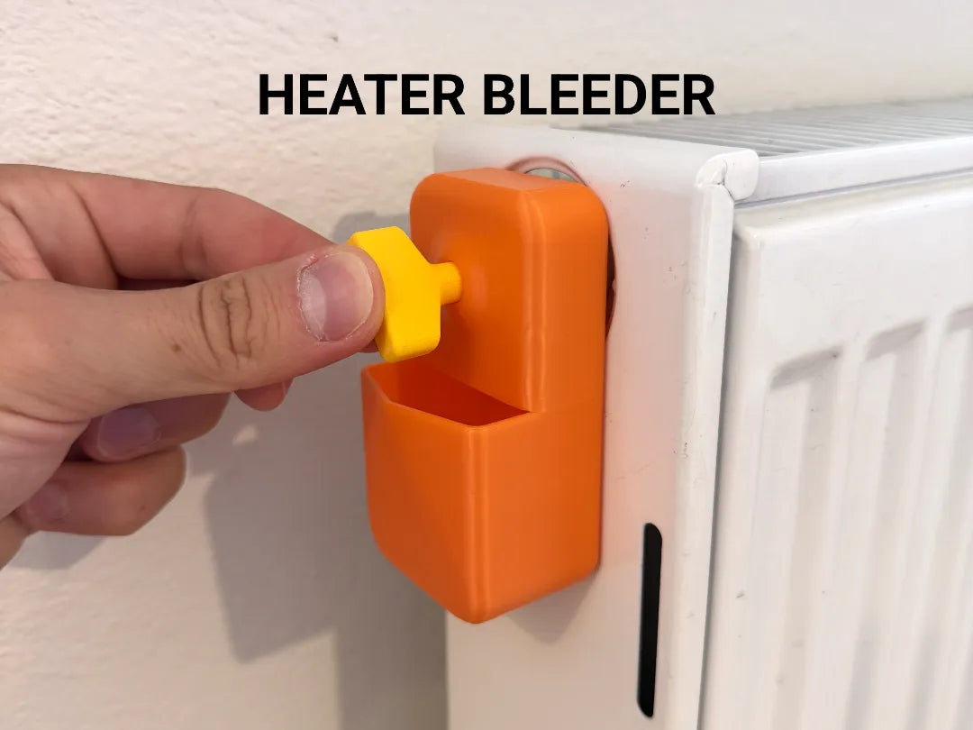 Orange Halterung mit gelbem Entlüftungsschlüssel am Heizkörper montiert, Nahaufnahme