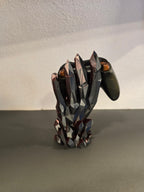 Kristallhand-Controllerhalter in Schwarz-Grau mit eingesetztem olivgrünem Gaming-Controller, Nahaufnahme von oben auf die Finger