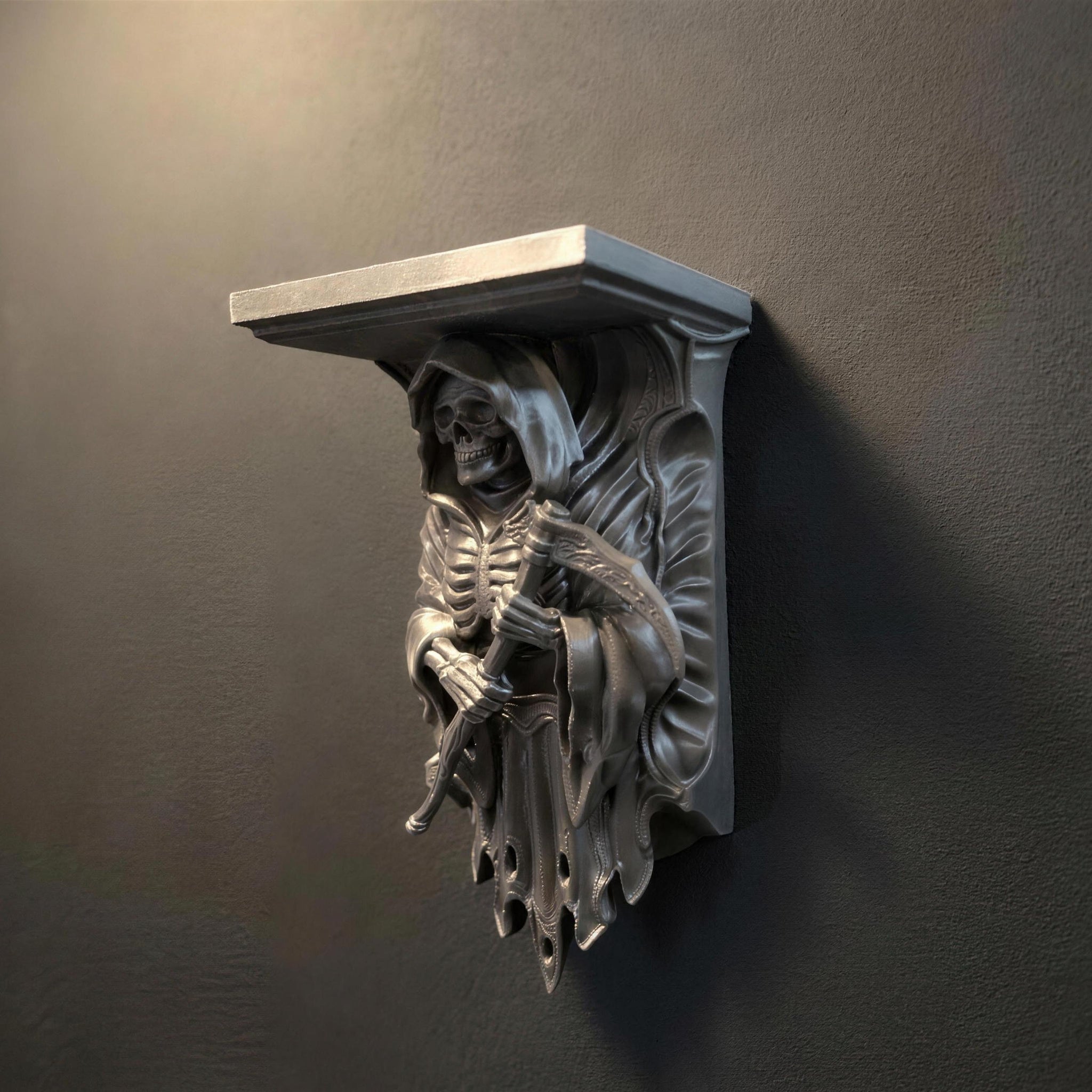 Grim Reaper wall shelf in metallic silver, front view mounted on a dark wall