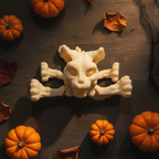 Nahaufnahme des Totenschädel-Kopfs der Skelett-Katze mit gekreuzten Beinknochen davor, Draufsicht auf Holztisch umgeben von Mini-Kürbissen und Herbstblättern