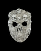 Ghoul-Totenkopf-Maske in Grau mit zahlreichen kleinen Schädeln auf der Oberfläche, Frontalansicht freigestellt vor schwarzem Hintergrund
